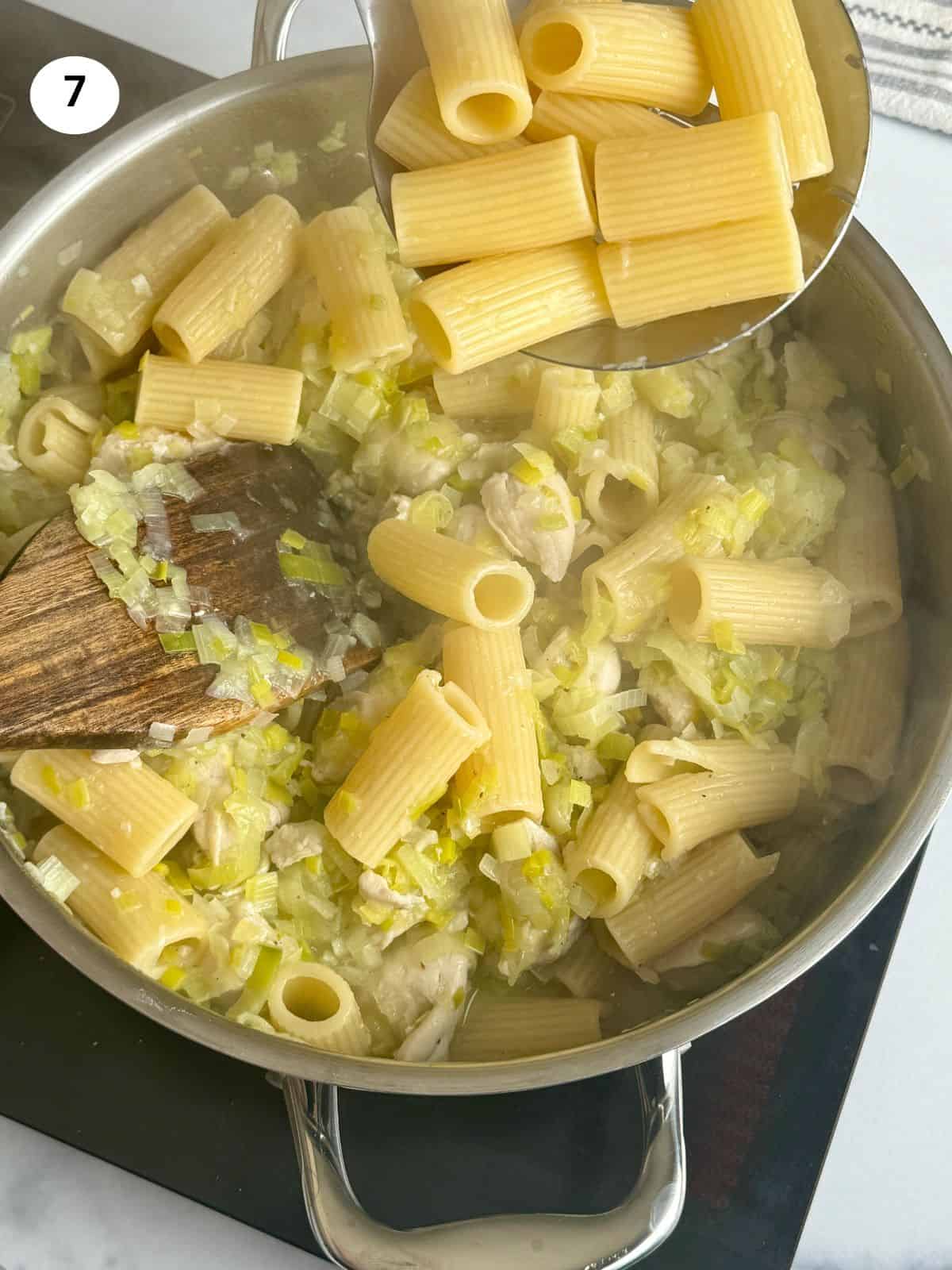 Adding the pasta to the pot.