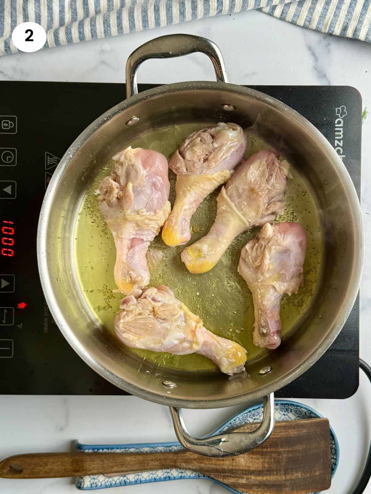 Browning the chicken drumsticks.