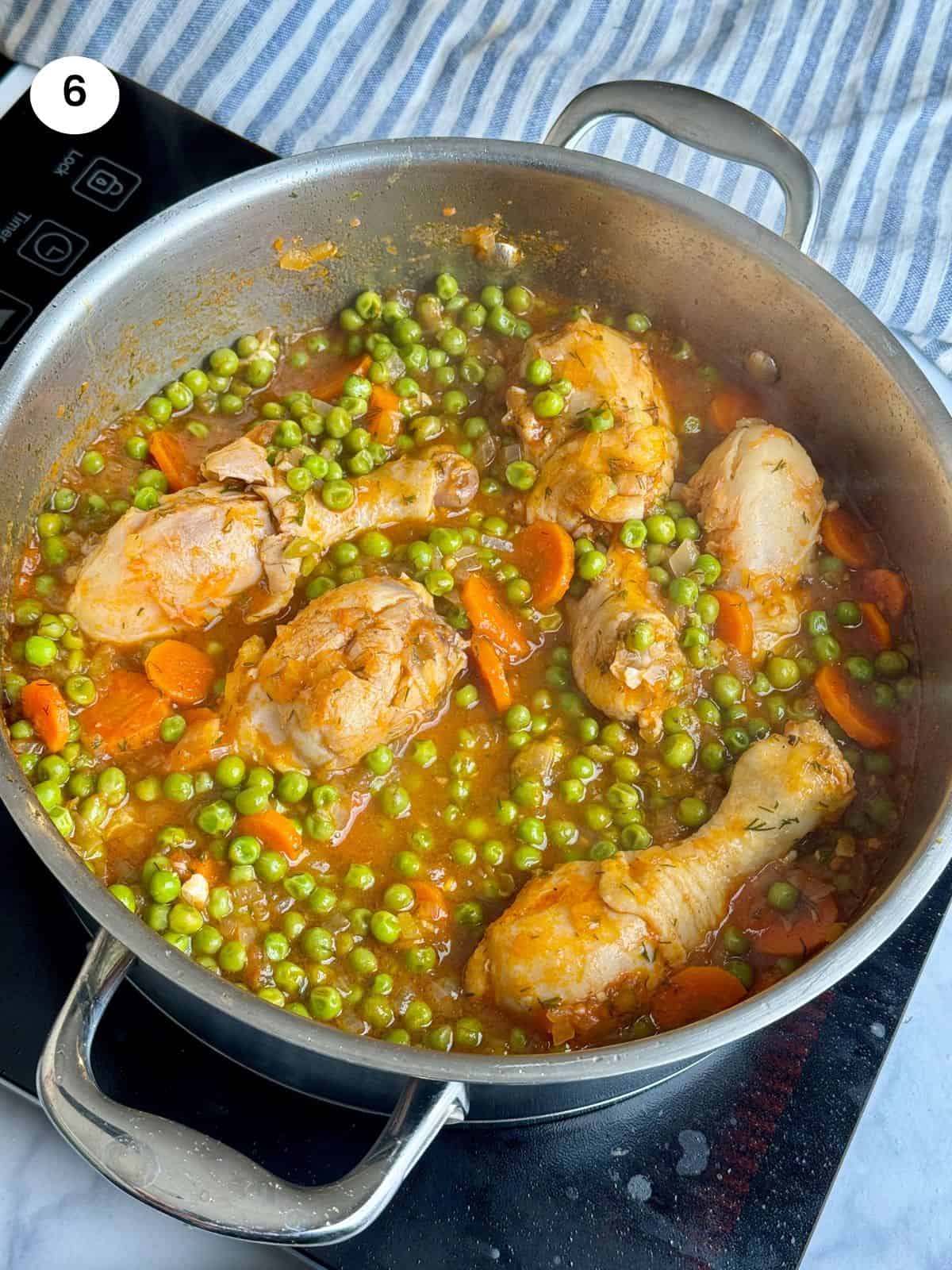 Chicken with peas when it is cooked and the sauce has thickened.