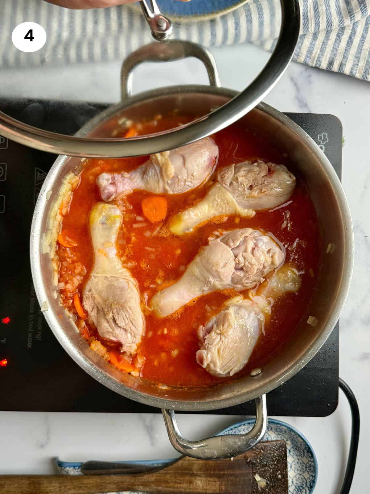 Chicken in the pot with the tomatoes.