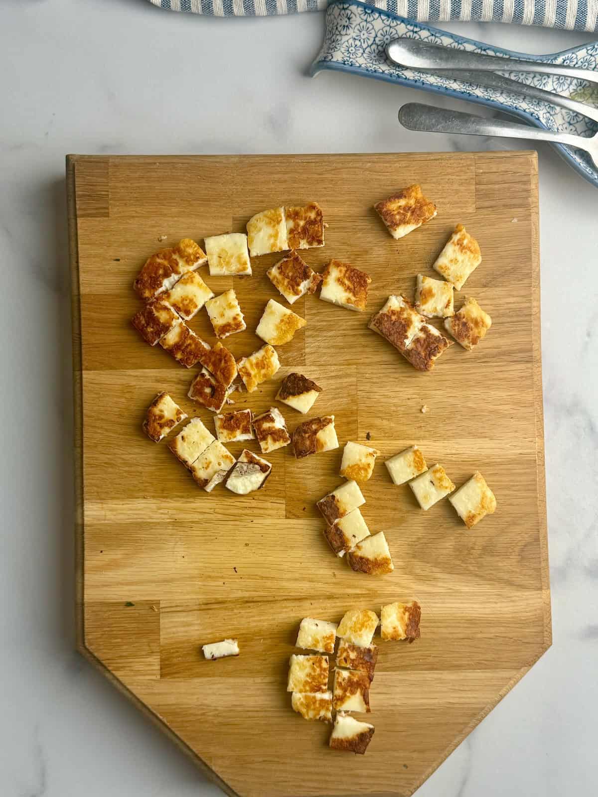 Cooked halloumi cut into squares.