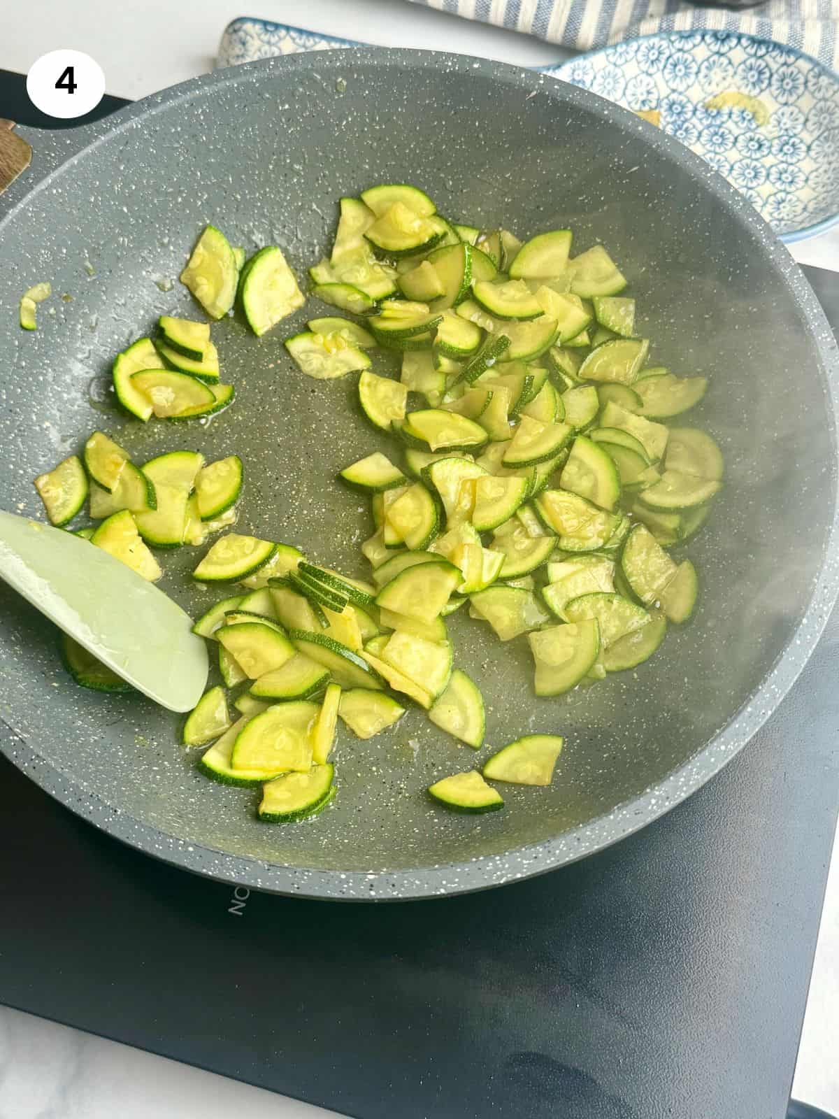 Cooked zucchini slices in the frying pan.