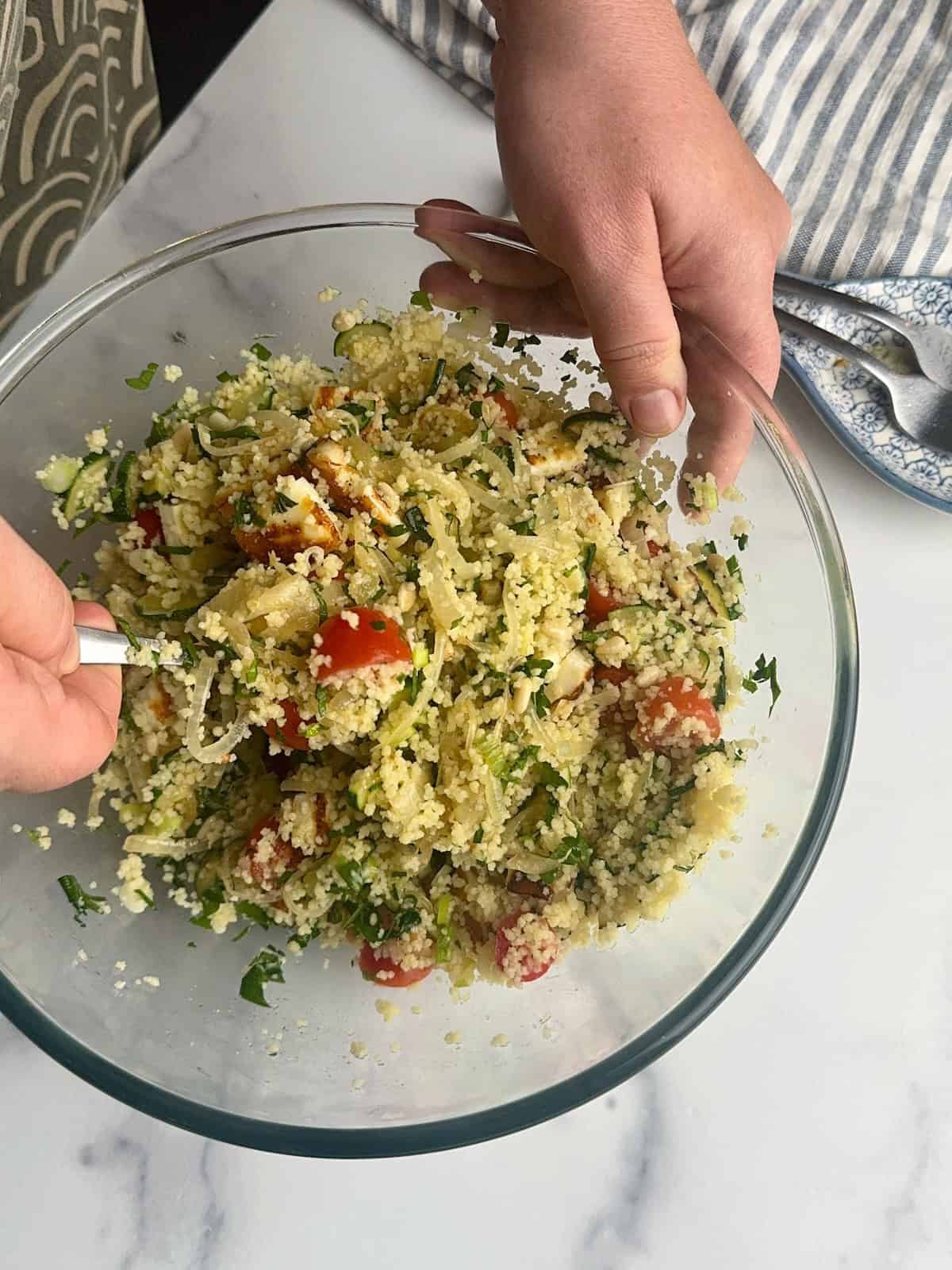 Mixing all the ingredients for the halloumi and couscous salad.