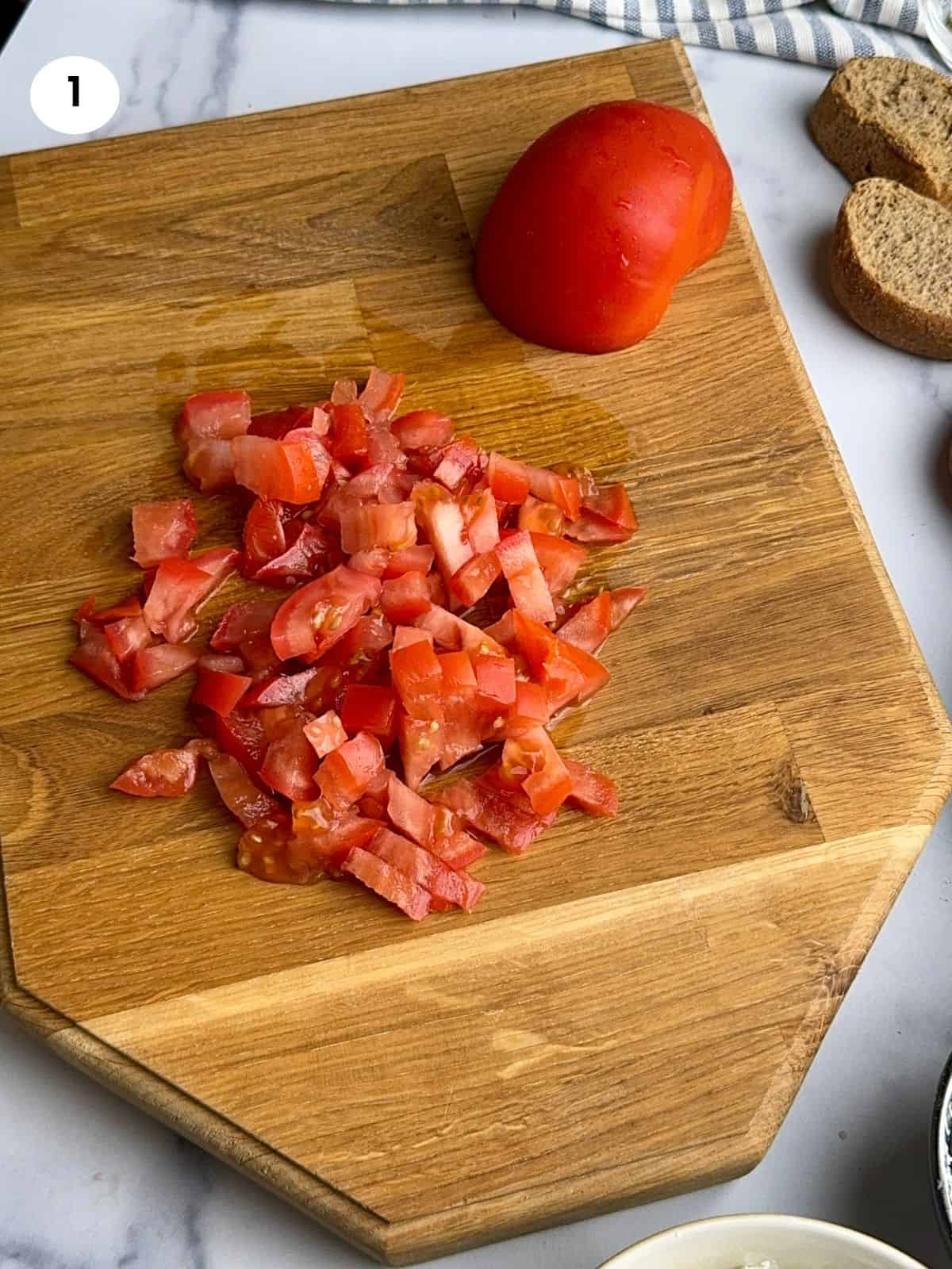 Diced tomato on wooden tray.