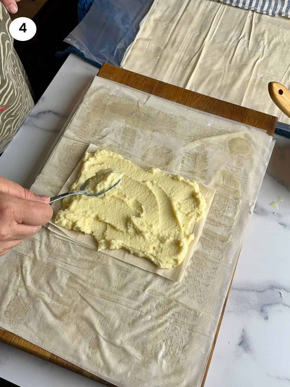 Addint the cream on top of the phyllo rectangle.