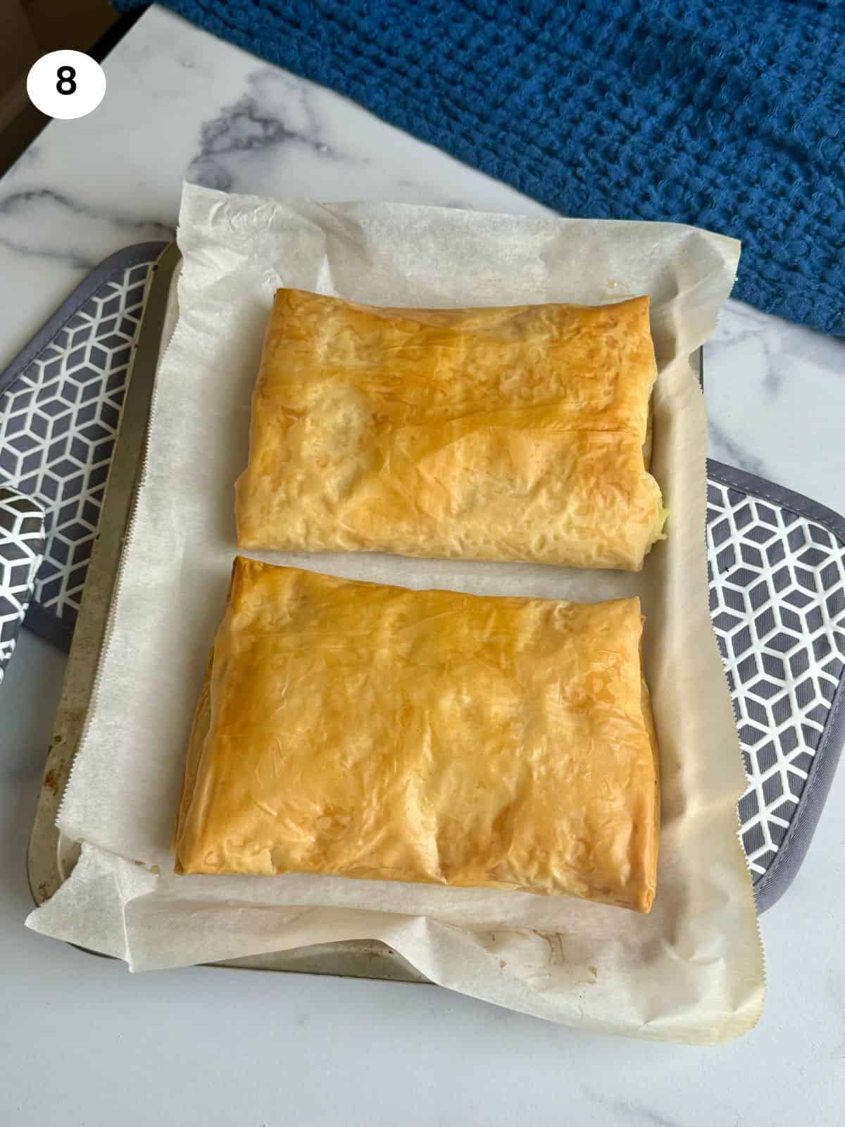 Bougatsa parcels when they come out of the oven on the tray.