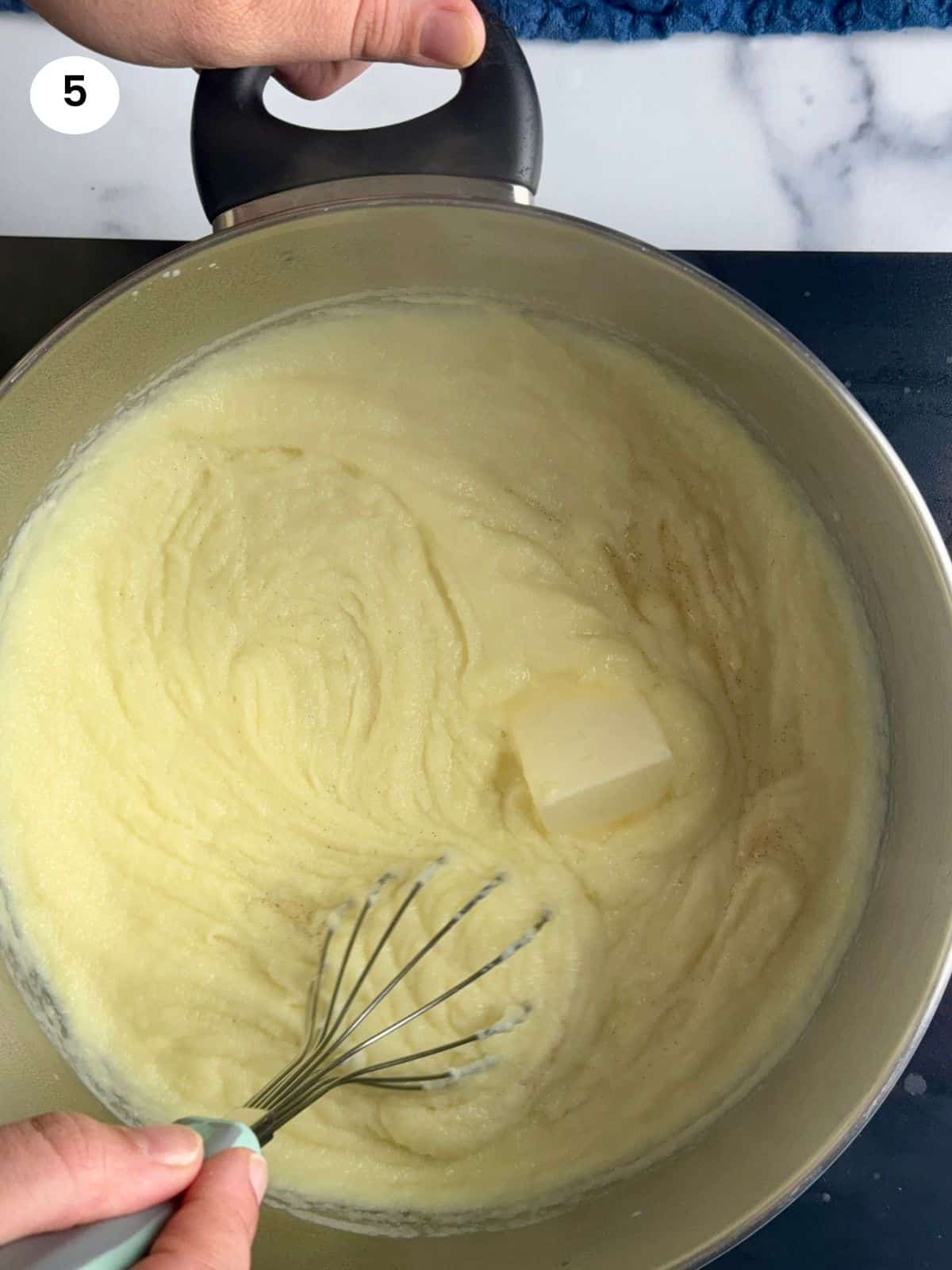 Melting the butter in the pot with the cream.