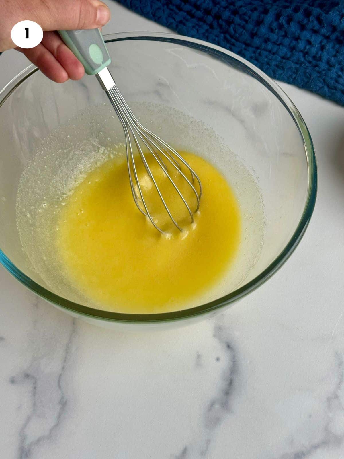 Mixing the eggs and sugar in a bowl.