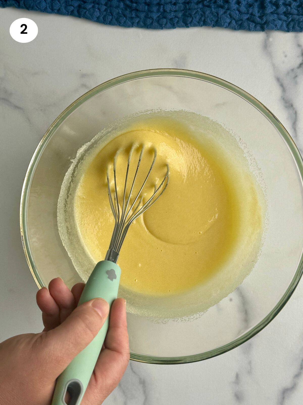 Whisking the batter after adding the semolina.