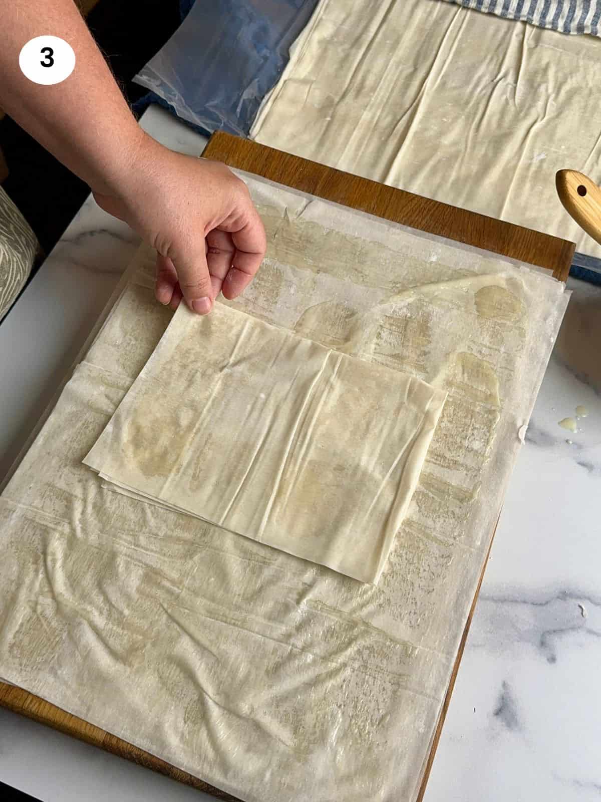 Placing the rectangle folded phyllo sheet in the middle.