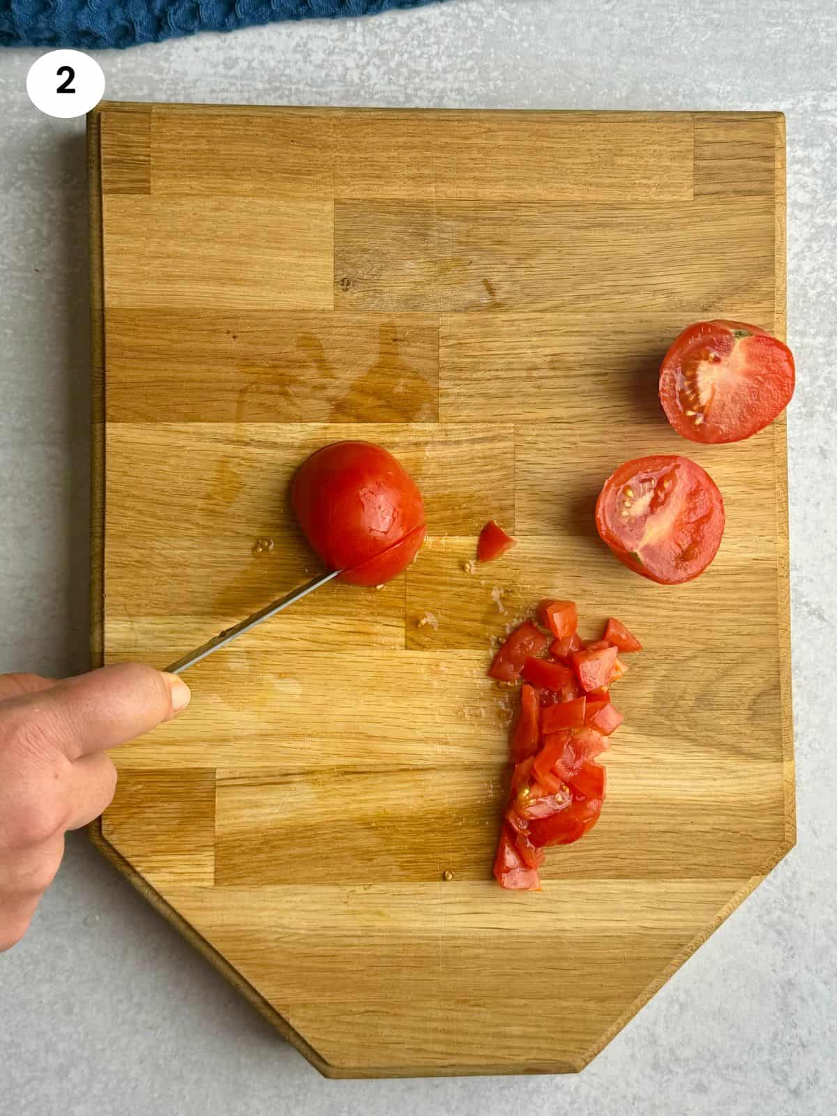 Diced tomato on wooden tray.