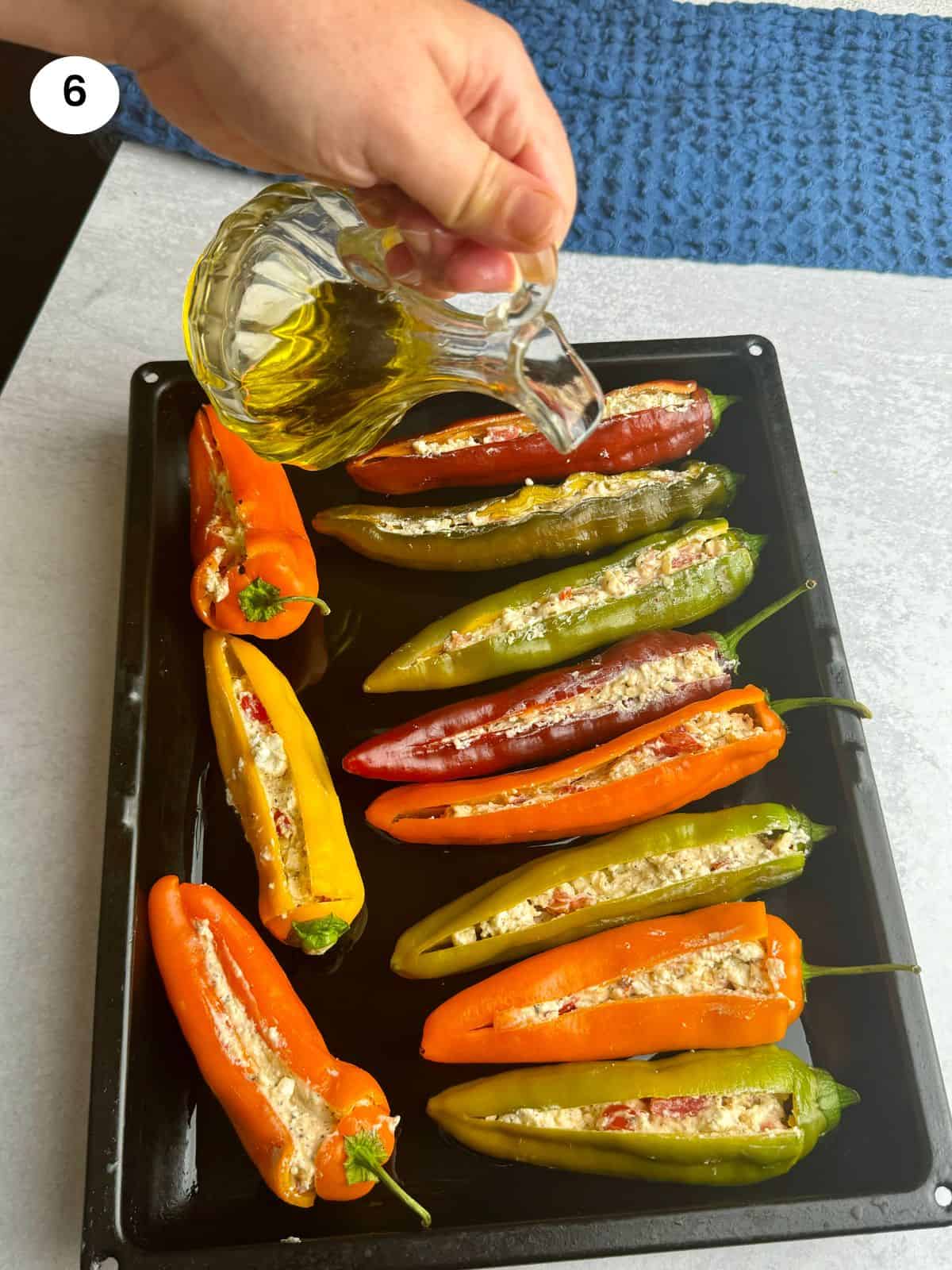 Drizzling oil on top of the peppers.