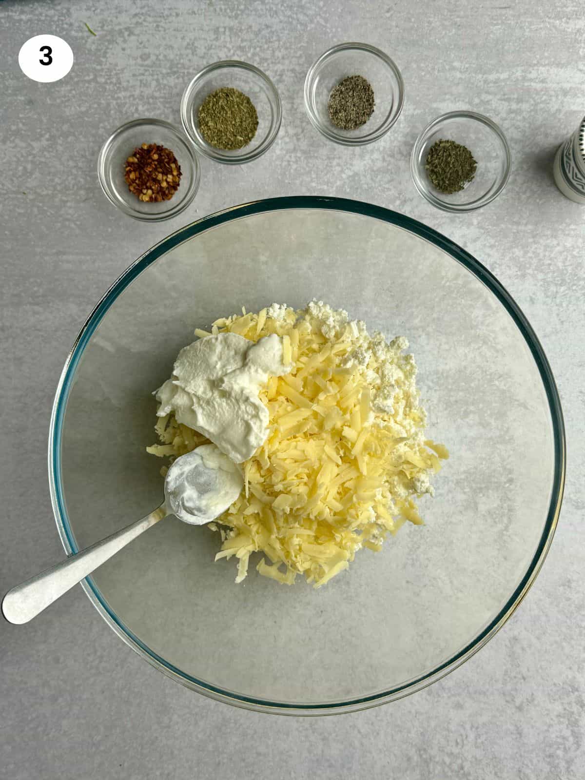 Placing cheese with a spoon on a rusk.