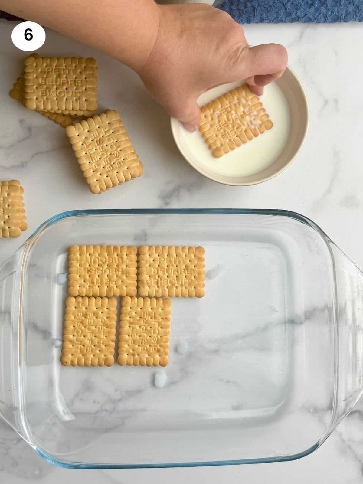 Laying the biscuits to the bottom of the pyrex.