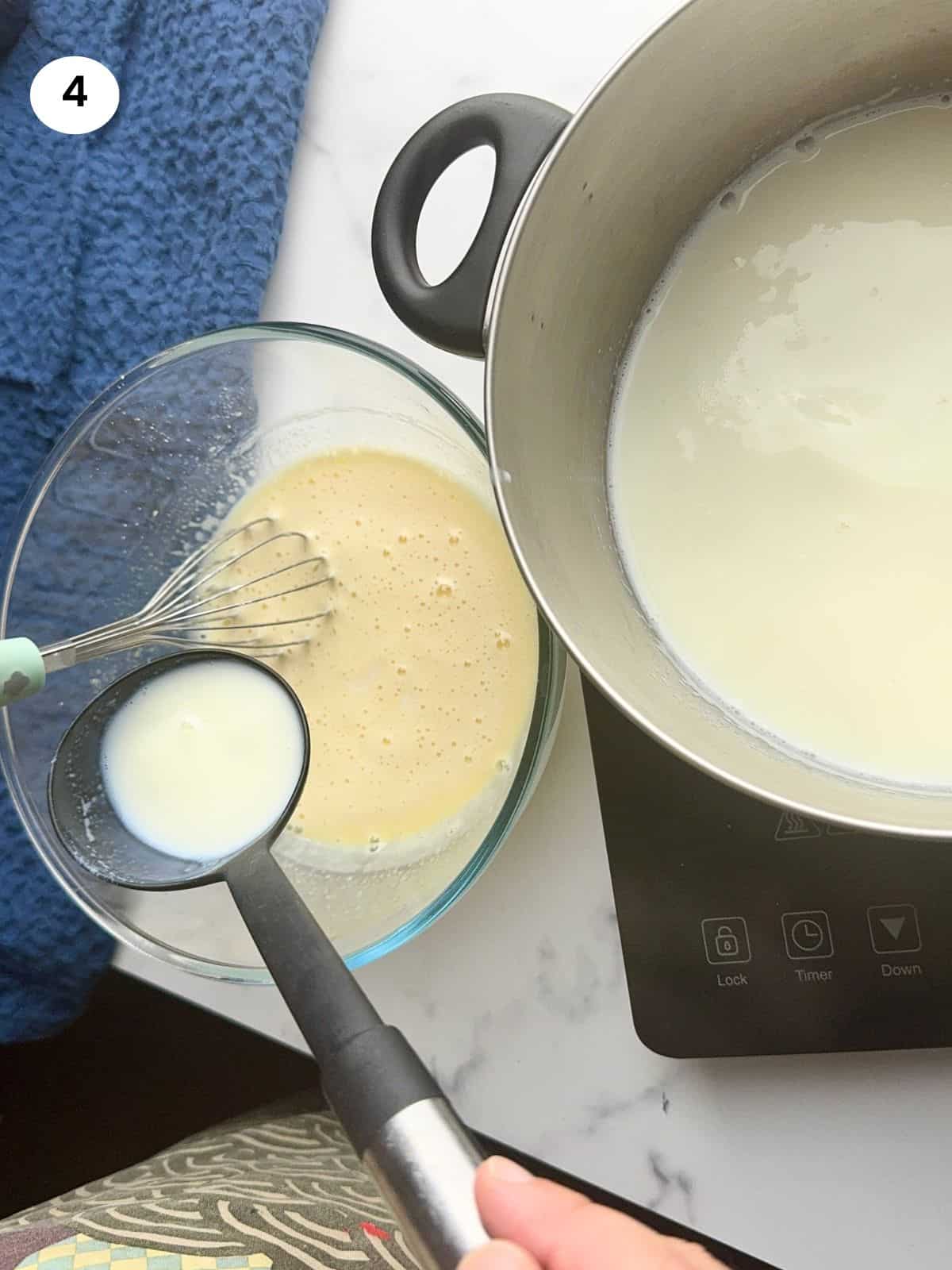 Pouring milk to the bowl using a ladle.