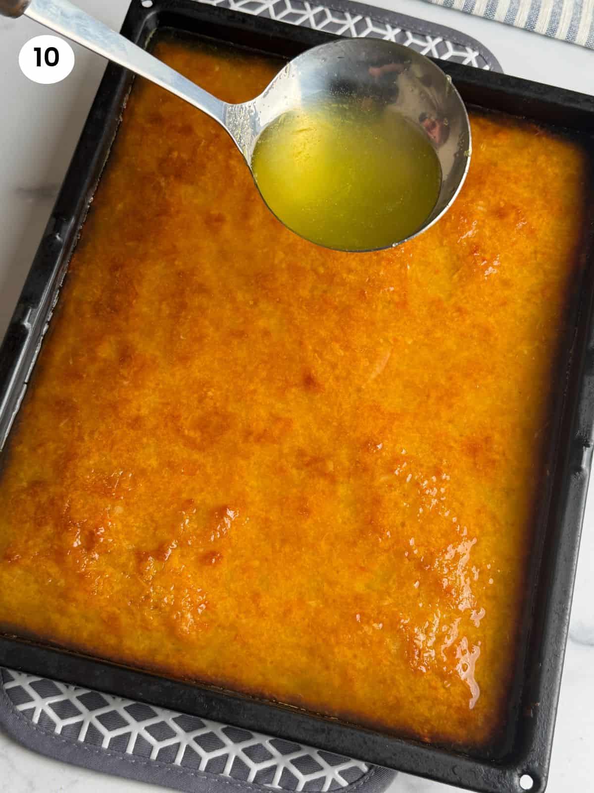 Adding the syrup to the baked orange cake.