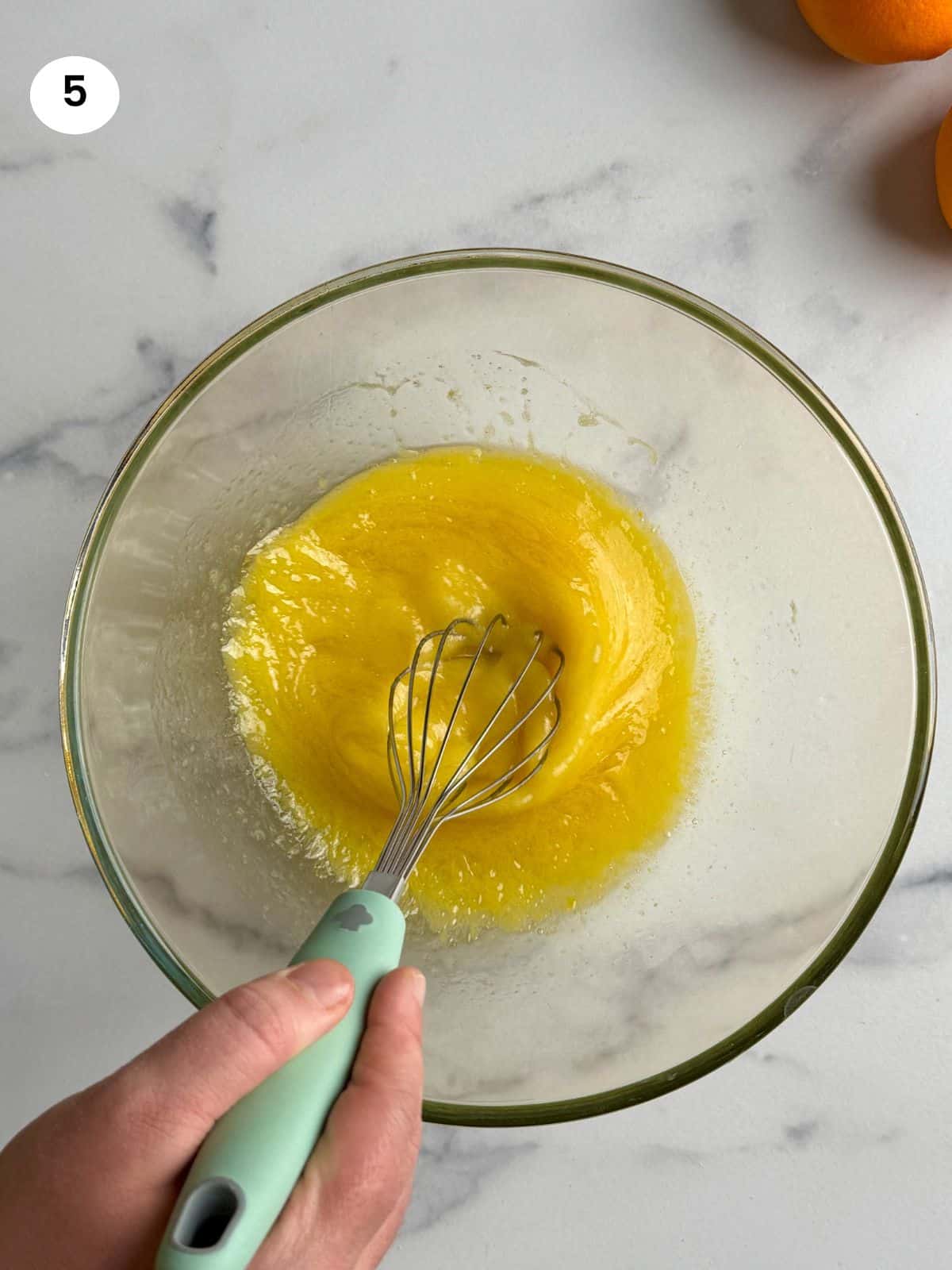 Mixing the sugar, oil and eggs until creamy.