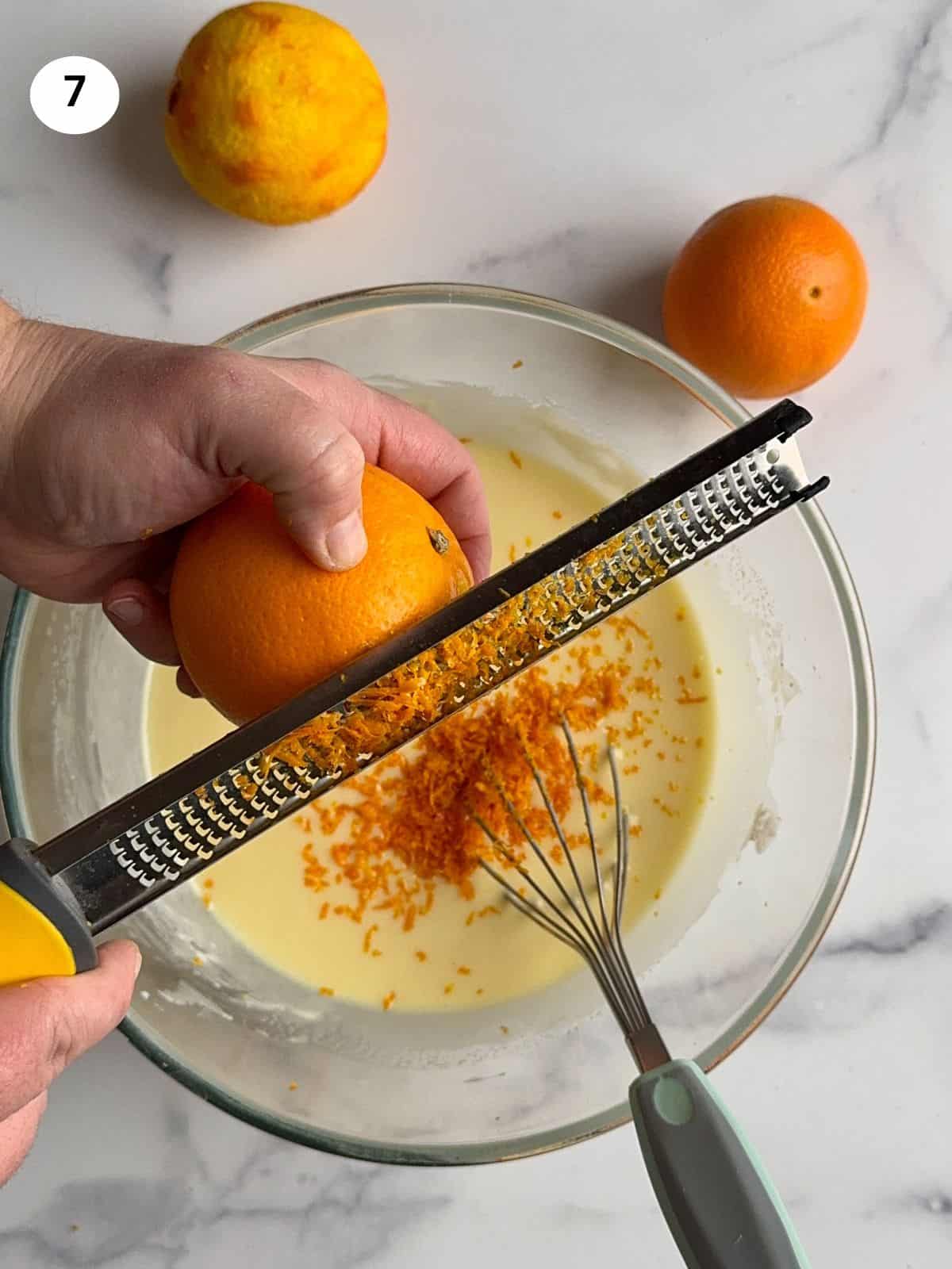 Adding the orange zest to the batter.