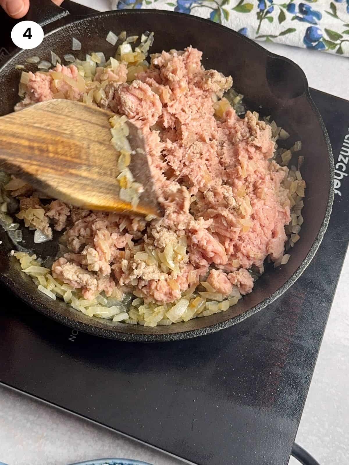 Browning the ground turkey in the skillet.