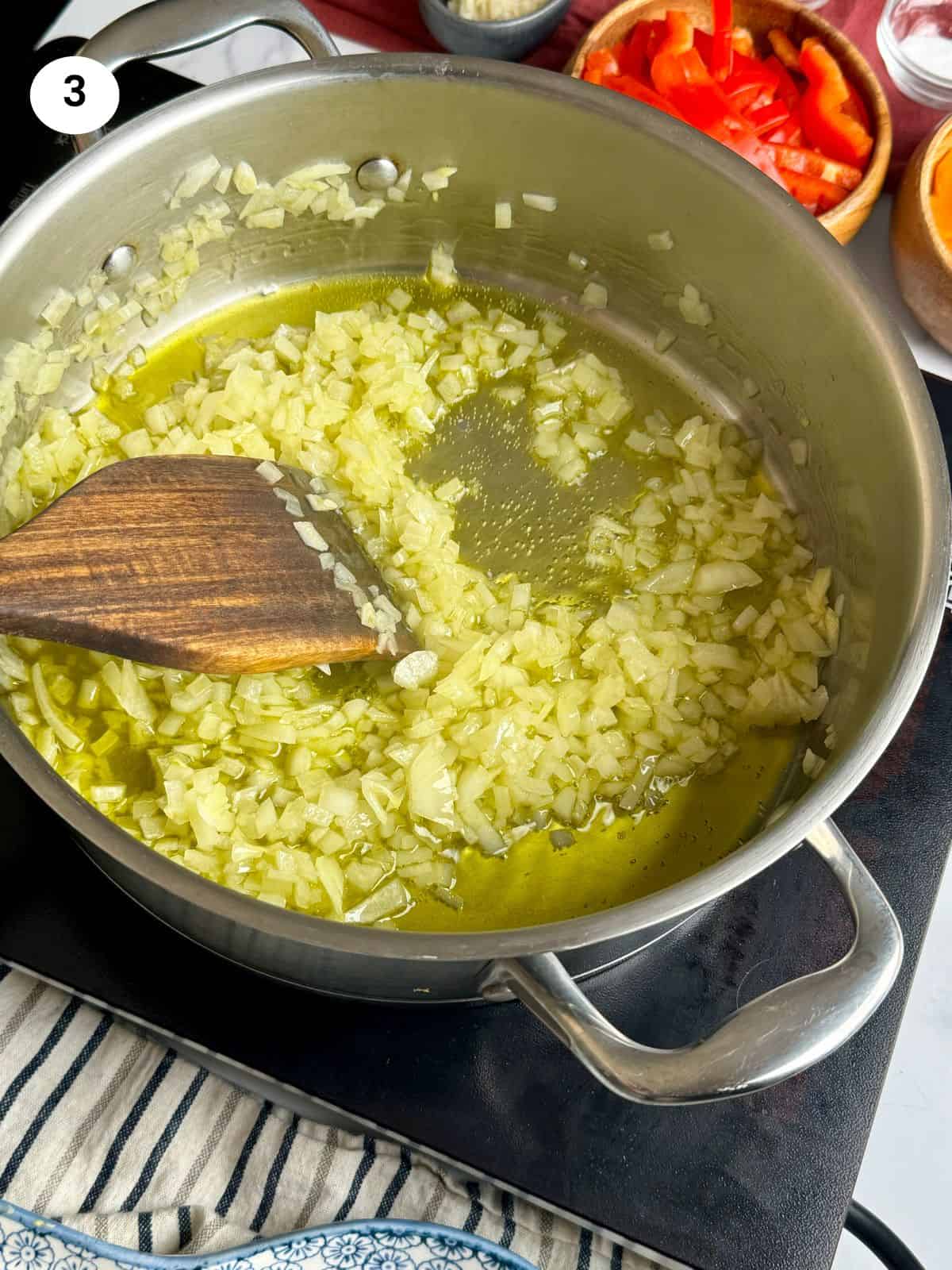 Sauteing the onion until translucent.