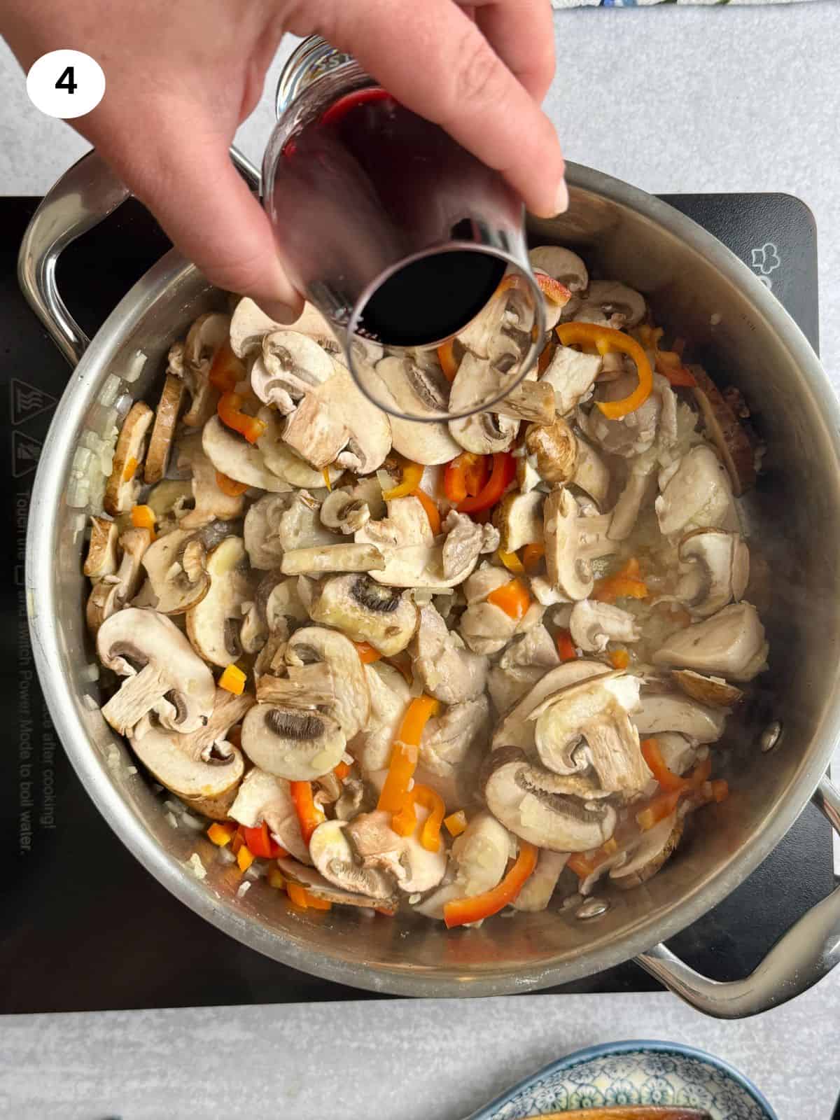 Adding red wine to the pan.