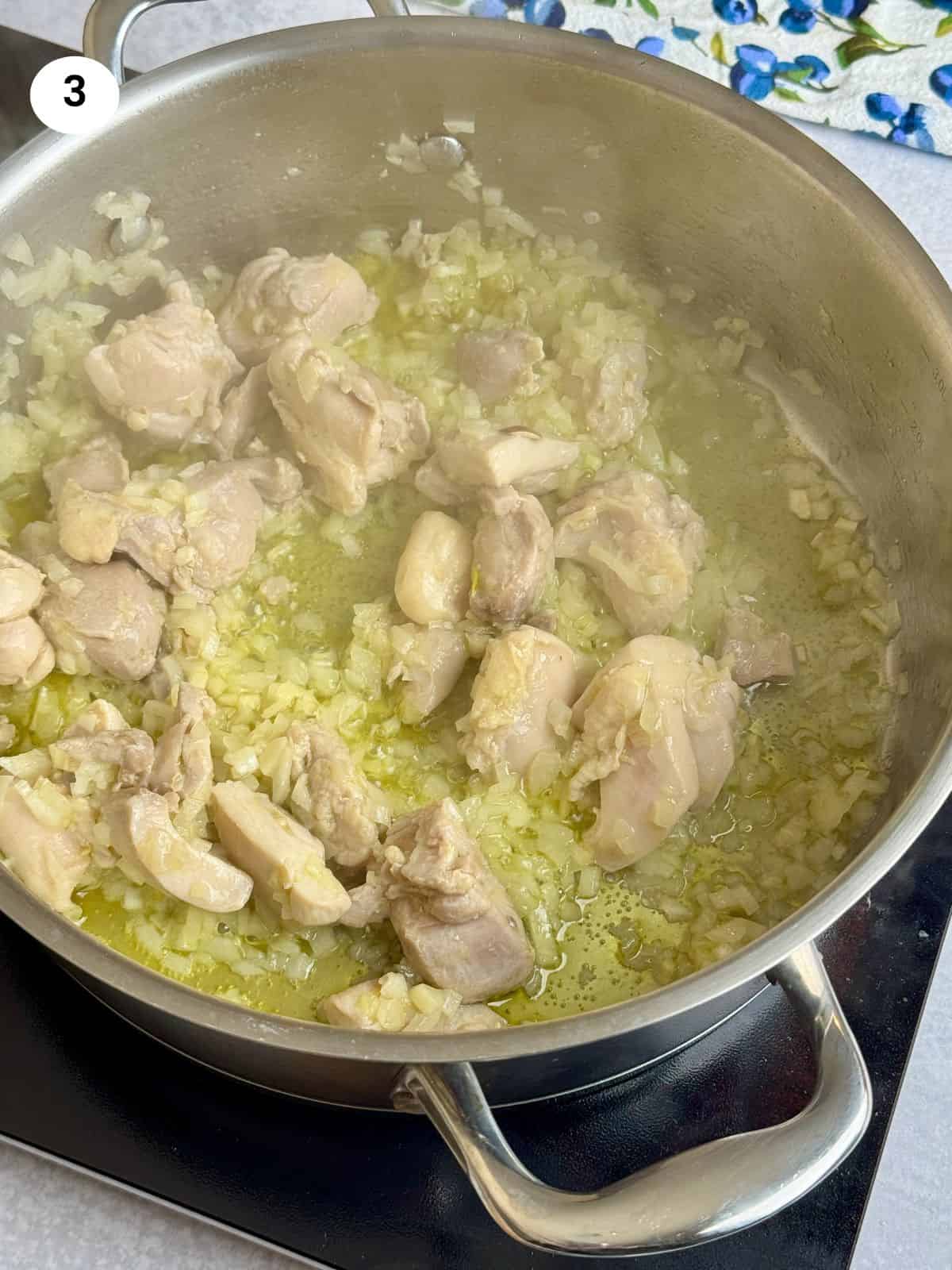 Sauteing the onion and garlic cloves.