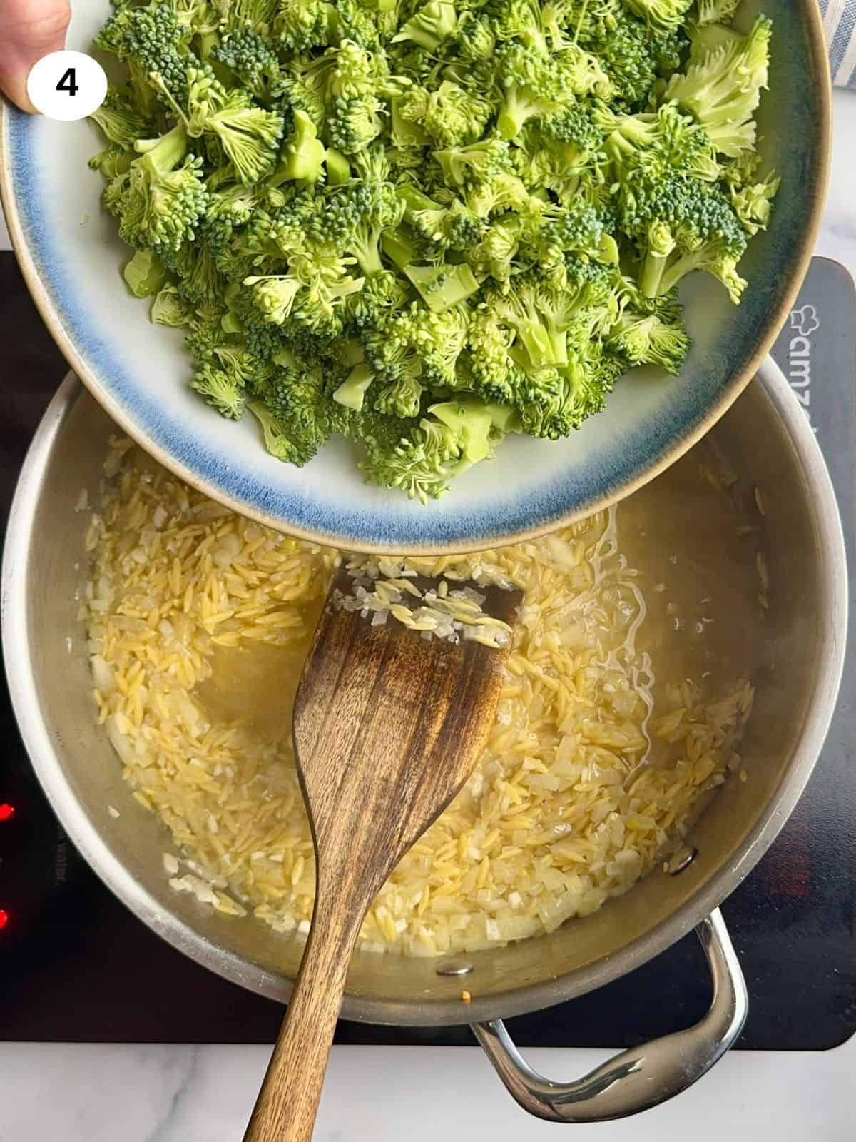 Adding the broccoli to the pan.