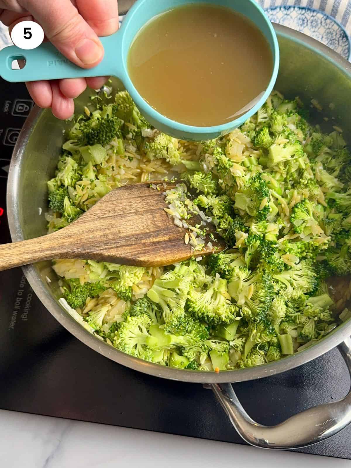 Adding broth to the pan.