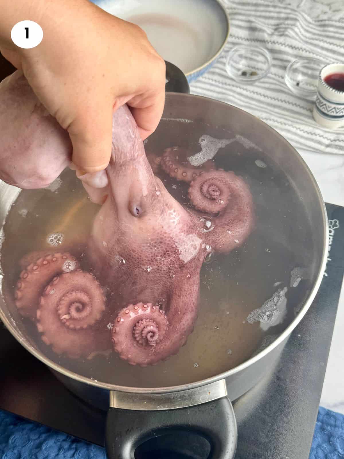 Dipping the raw octopus in the water.