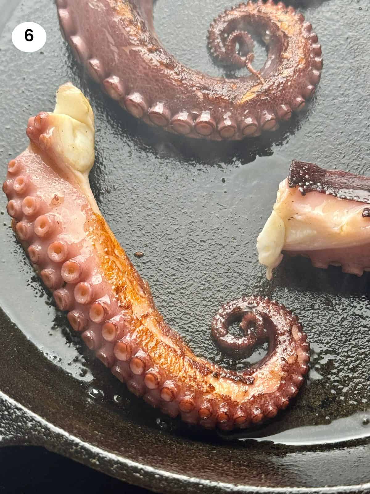 Octopus tentacles on a frying pan.