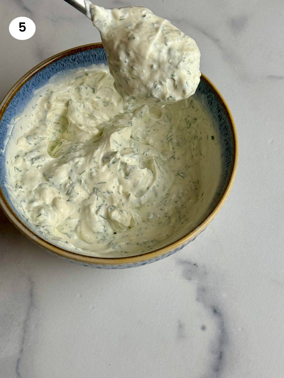 Mixing the Greek yogurt dressing ingredients in a small bowl.