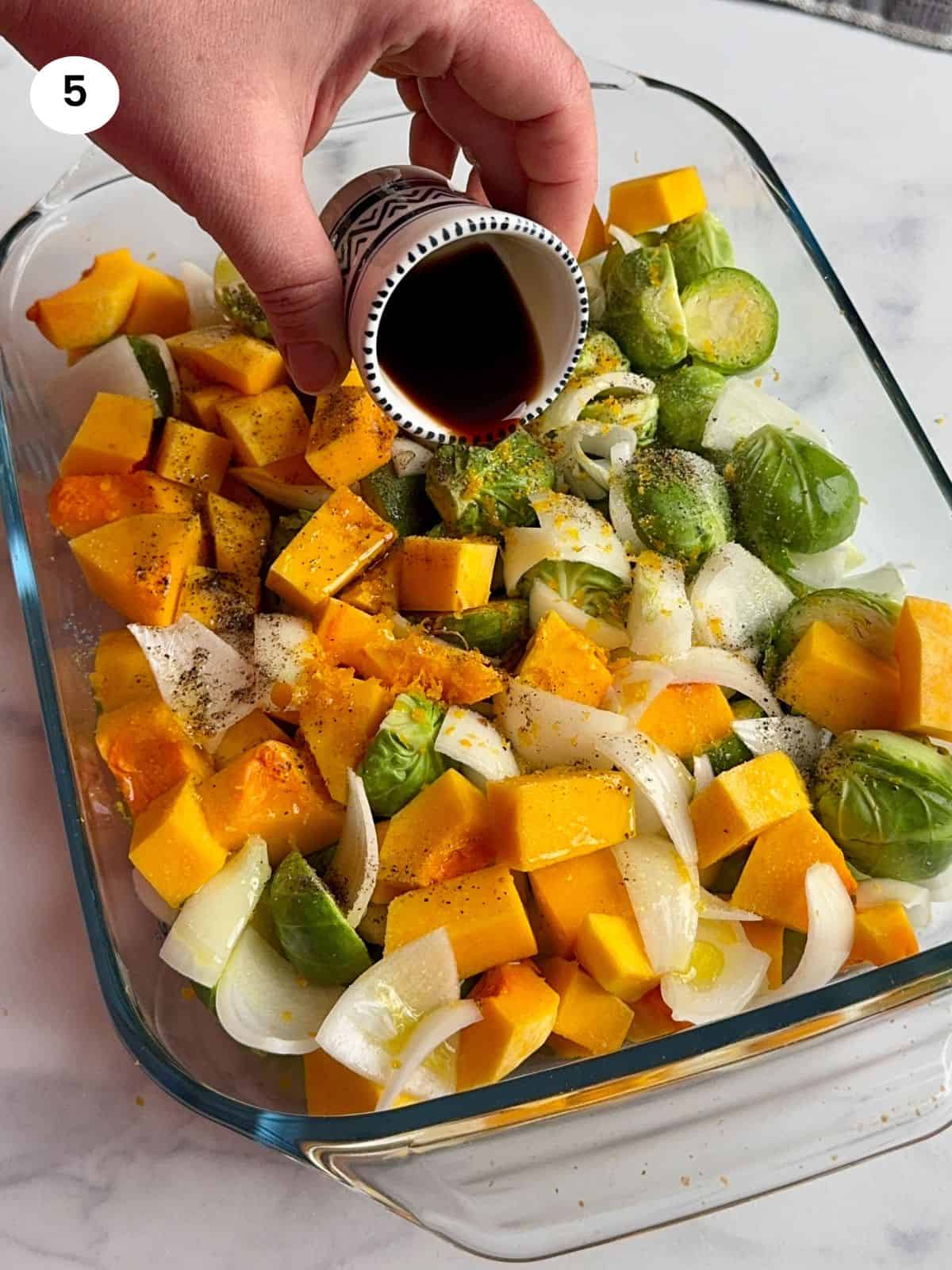 Pouring the balsamic vinegar in the casserole dish.