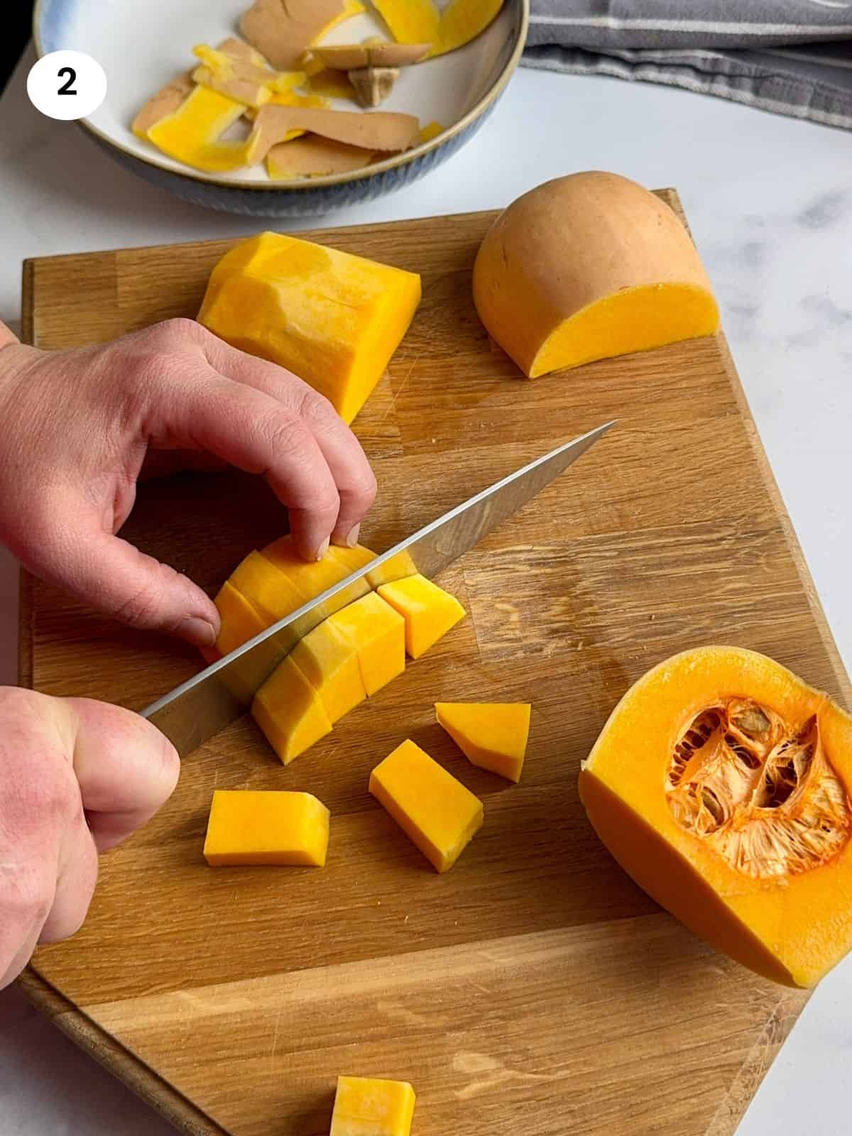 Cutting the butternut squash into big chunks.