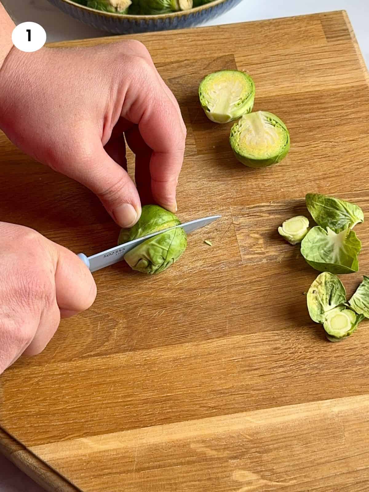 Cutting the brussels sprouts into halves.