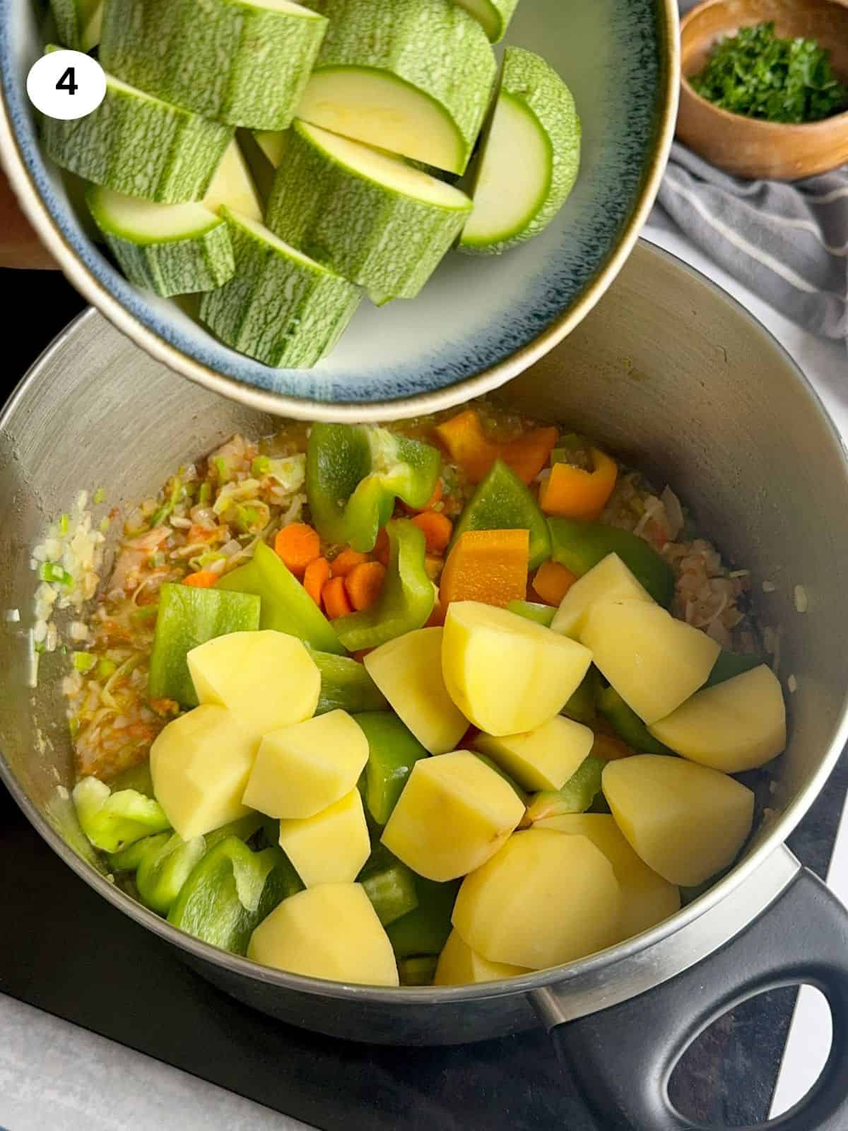 Adding the veggies to the pot.