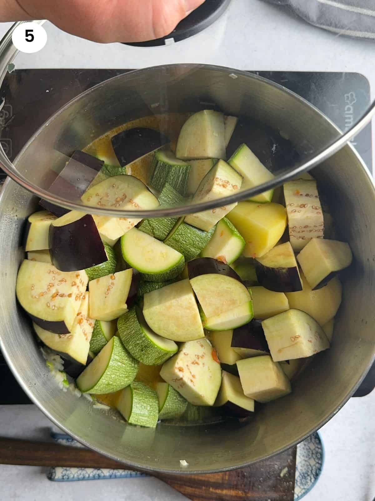 Cover with a lid and let the veggies slowly cook.