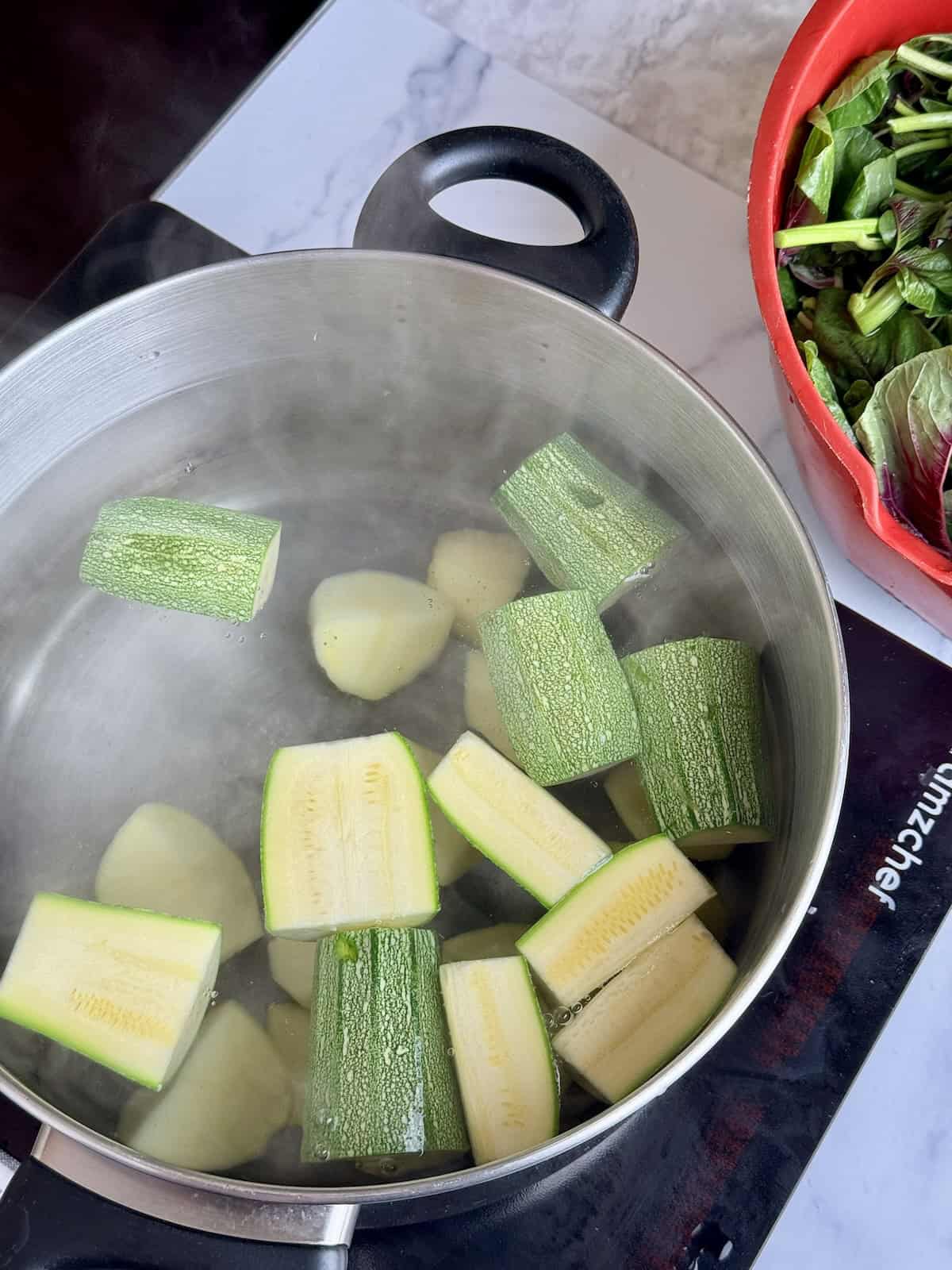 Boiling the veggies before adding the greens in.