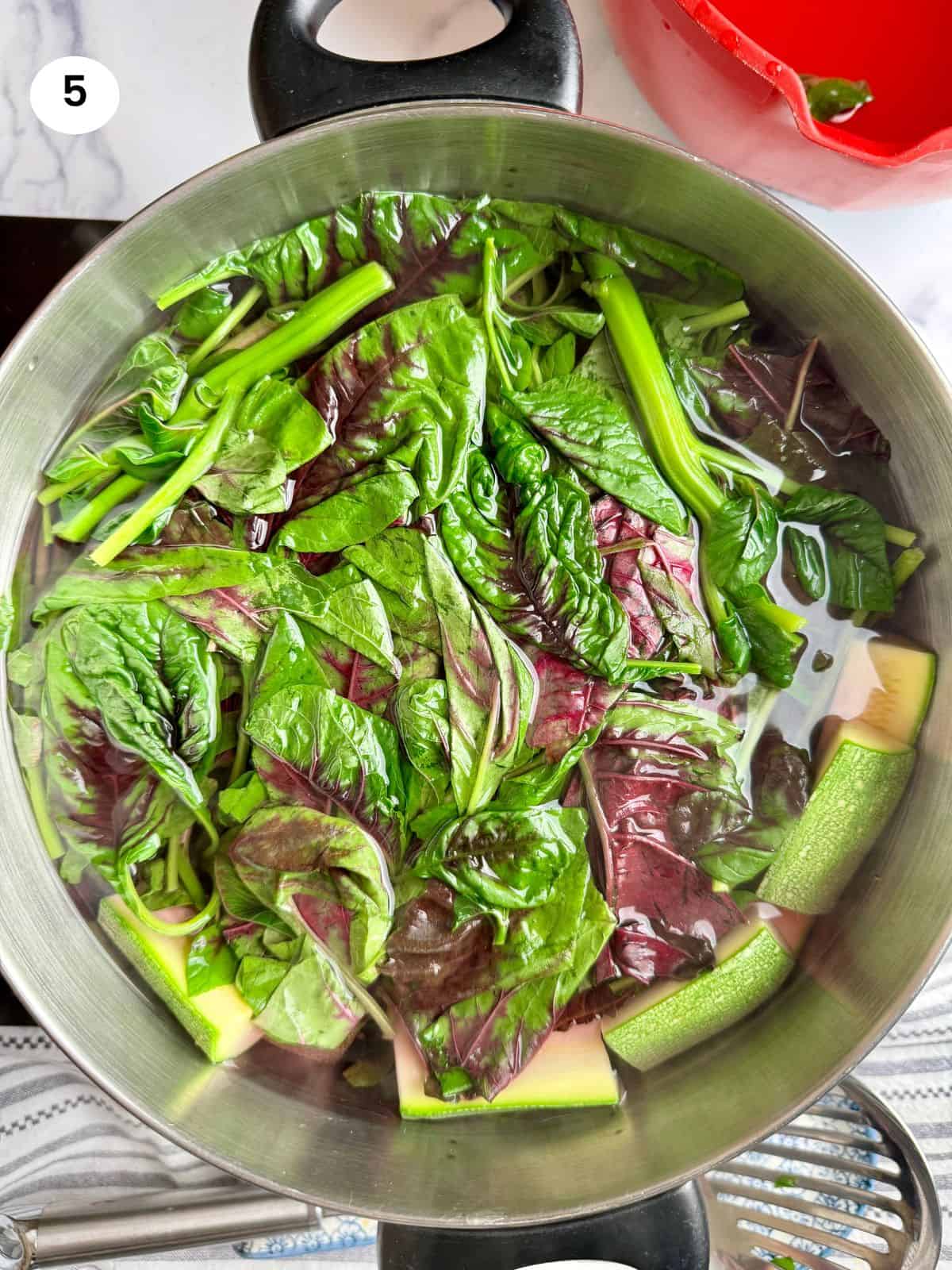 Amaranth greens added to the pot.